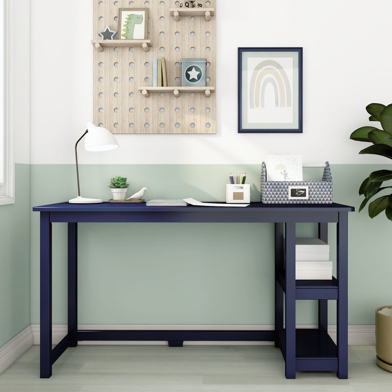 Contemporary study room with a navy blue desk, modern white lamp, decorative wall shelves, and green accents.