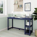Modern navy blue writing desk with open shelving in a bright small home office, mint green half-wall, lamp, potted plant and pegboard decor