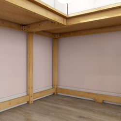 Empty room with wooden beams and pale pink walls, showcasing minimalist interior design.