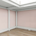White metal bed frame corner against pastel pink walls and light hardwood floor, modern minimalist bedroom interior
