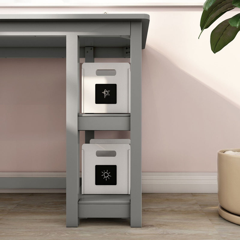 Under-desk storage solution — gray desk with two white fabric storage cubes on shelves against a blush pink wall and hardwood floor