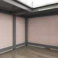 Grey metal bed frame corner with sturdy support legs and crossbeam on hardwood floor against a pale pink bedroom wall