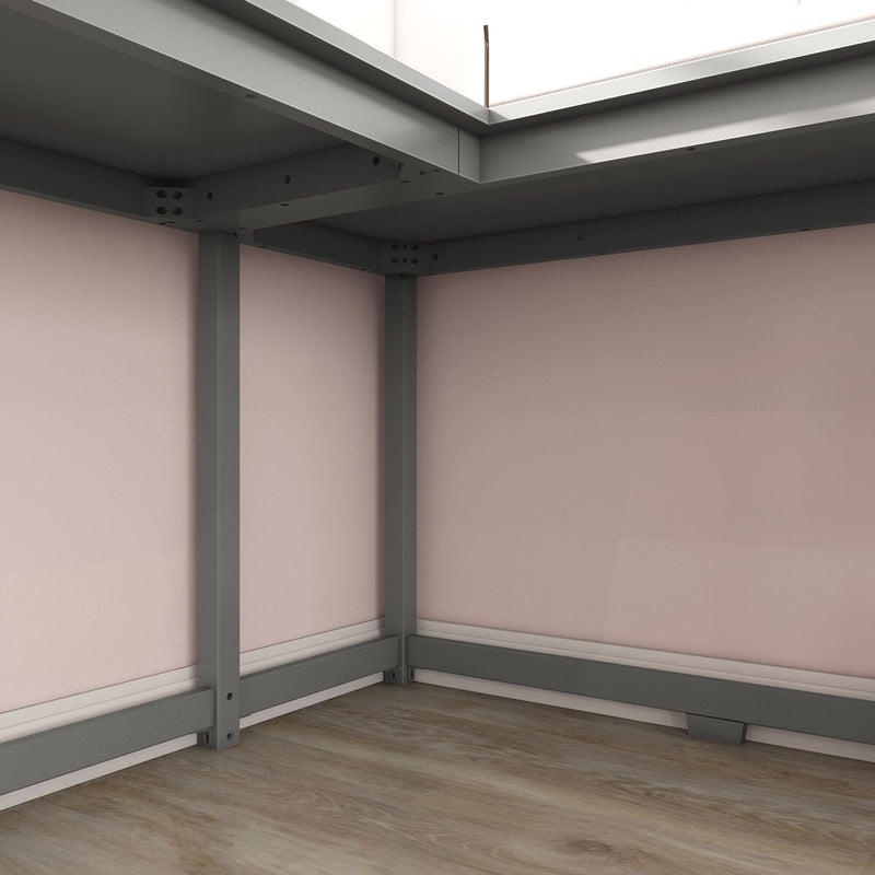 Grey metal bed frame corner with sturdy support legs and crossbeam on hardwood floor against a pale pink bedroom wall