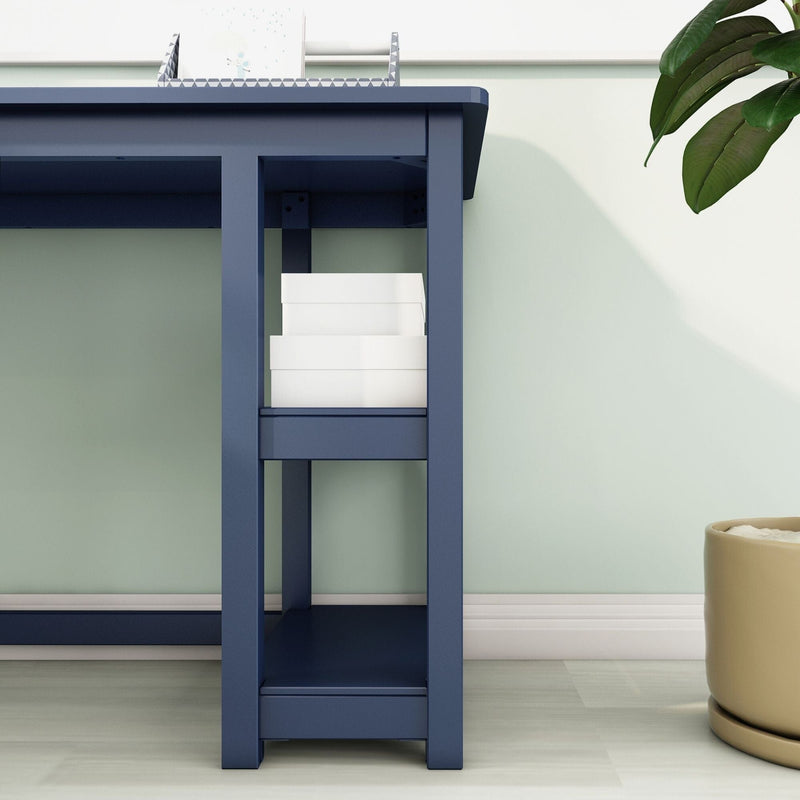 Modern navy blue desk with built-in shelf holding stacked white storage boxes against a mint green wall and potted plant