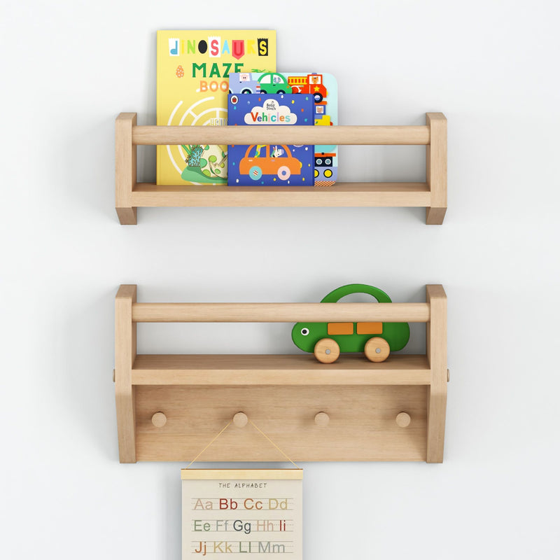Wooden wall shelves in a nursery holding colorful children's books, a green wooden toy turtle and a hanging alphabet poster for kids room decor