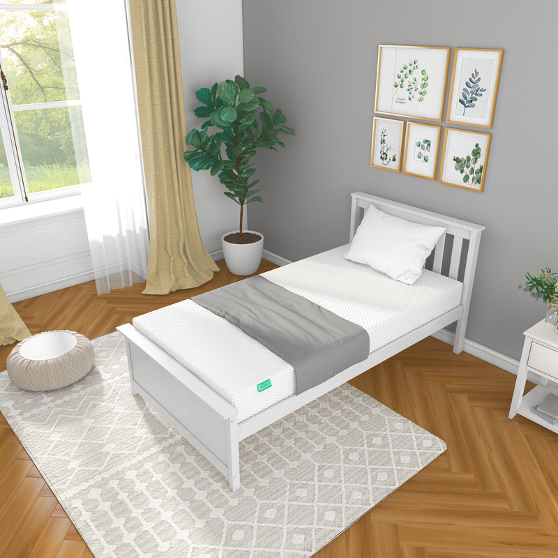 Modern bedroom with a minimalist single bed featuring a white mattress, green plant, and wall art for a cozy and stylish interior design.