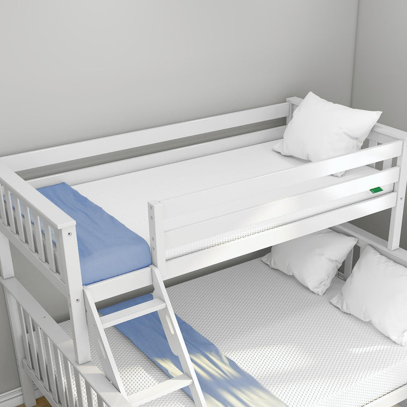 White wooden bunk bed with ladder and safety guardrail, blue blanket, mattresses and pillows in a minimalist kids' bedroom, space-saving design
