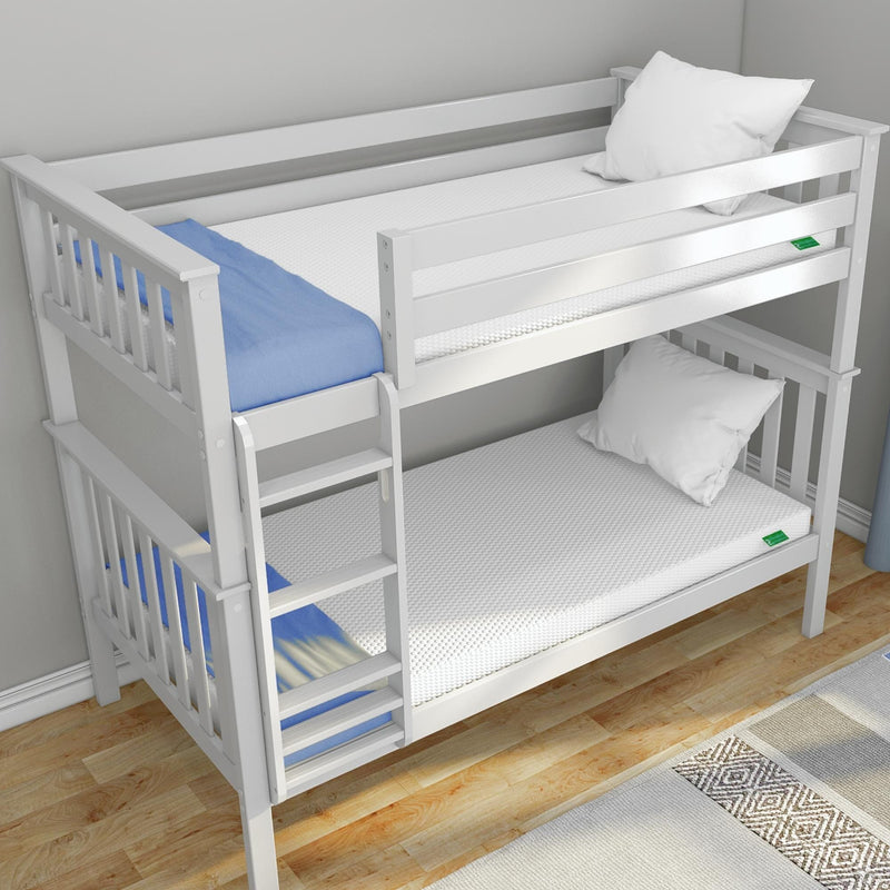 White wooden twin bunk bed with ladder and guardrails, two white mattresses and pillows, blue blanket, hardwood floor and rug in a modern kids' bedroom