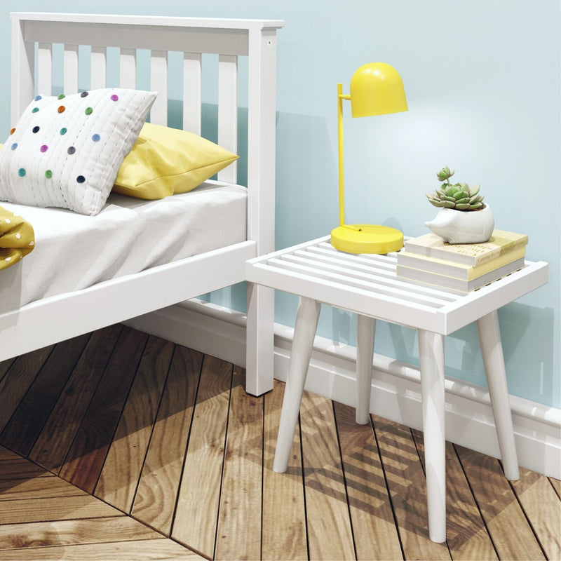 Modern bedroom interior with white bed, wooden nightstand, yellow lamp, and potted succulent for cozy decor.