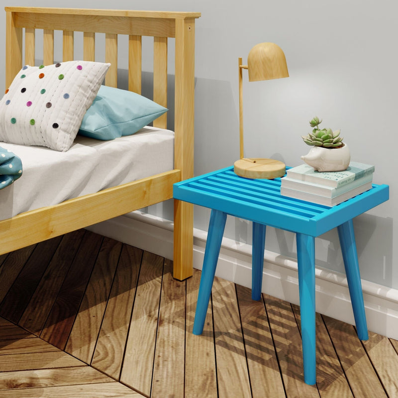 Blue wooden side table with a modern lamp, succulent plant, and books next to a cozy wooden bed in a stylish bedroom.