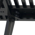 Close-up of a black metal furniture frame corner showing sturdy construction and bolts.
