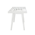 White slatted wooden bench with angled legs in modern minimalist design.