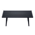 Modern black slatted coffee table with sleek minimalist design and angled legs.