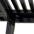 Close-up of sturdy black metal furniture frame and screws, showcasing industrial design and durability.