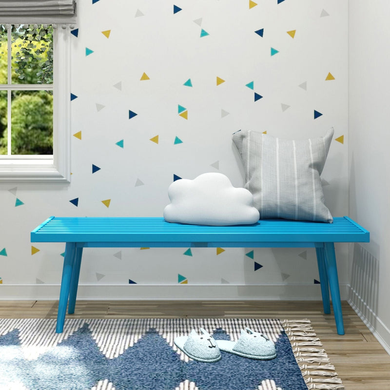 Colorful kids' room with blue bench, cloud cushion, and modern geometric decor.