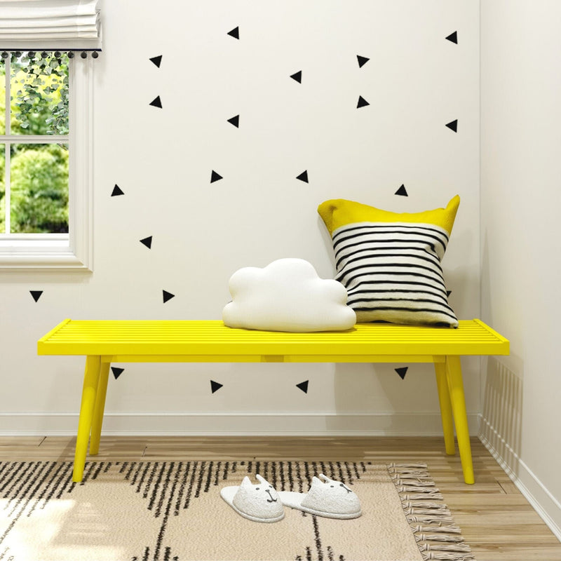 Cozy corner with a yellow bench, striped pillow, and fluffy cloud decoration in a modern living room.