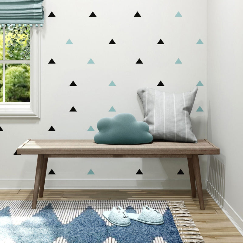 Cozy kids room decor with wooden bench, cloud pillow, geometric wall decals, and plush slippers.