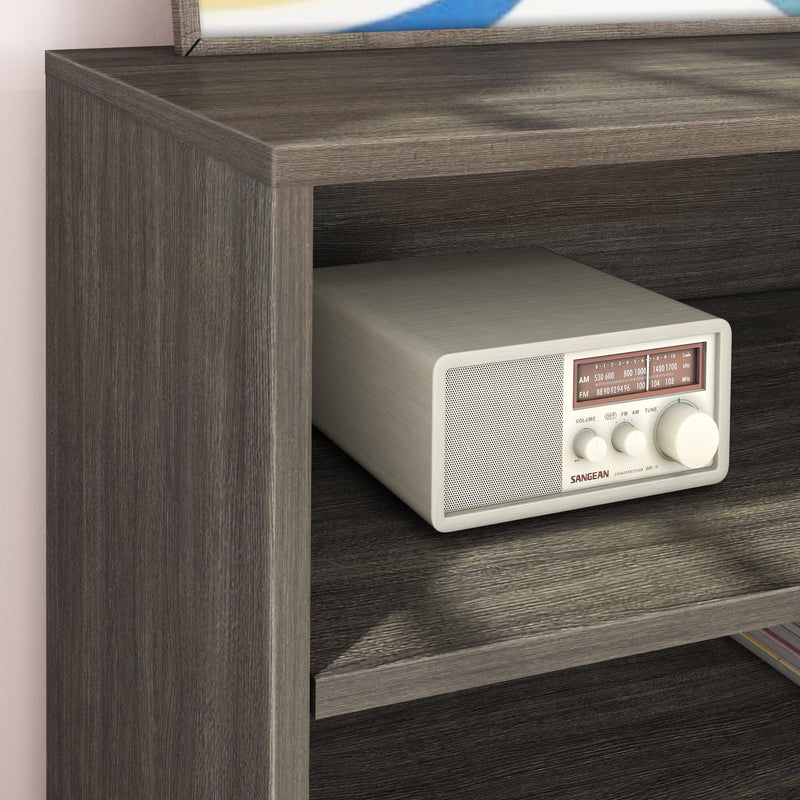 Vintage radio on a wooden shelf, showcasing retro design and classic AM/FM tuning.