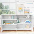 Bright modern nursery shelf with framed sun-and-waves print, yellow toy van, white ukulele, pastel rainbow toy, turquoise cactus figurine, children's books and potted plants on white shelving by a large window overlooking evergreen trees, minimalist kids room decor.