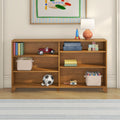 Wooden kids bookshelf and toy storage in nursery with table lamp, blue toy rocket, red ride-on car, alphabet blocks, books and plush soccer ball