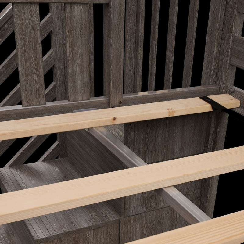 Garden bench assembly showing light pine slats, black mounting strap and central metal support beam installed on a weathered gray wooden frame and backrest