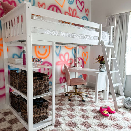 Loft bed with study desk in colorful teen bedroom with graffiti art wall and cozy decor.
