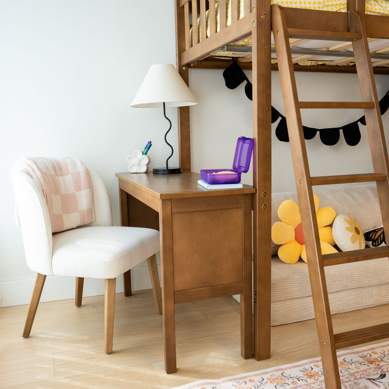 Cozy children's bedroom with a wooden loft bed, study desk, and decorative flower pillows.