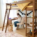 Child studying at a wooden loft bed with built-in desk and shelving, yellow gingham bedding and cozy kids study nook with natural light and organized storage