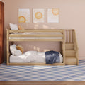 Light wooden bunk bed with stairs in blush-pink kids' room, sun wall art, cloud cushions and blue plaid rug