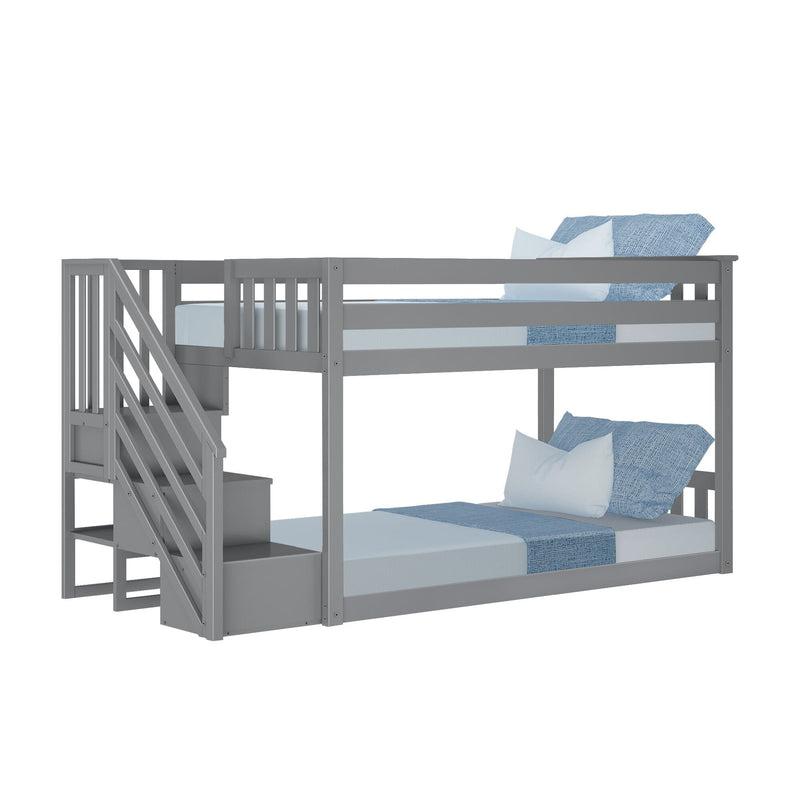 Gray wooden bunk bed with stairs and blue bedding, ideal for kids' rooms.