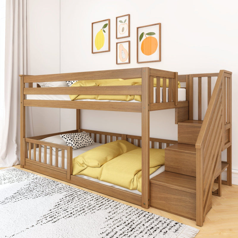 Wooden bunk bed with stairs in a modern bedroom featuring yellow bedding and fruit-themed wall art decor.
