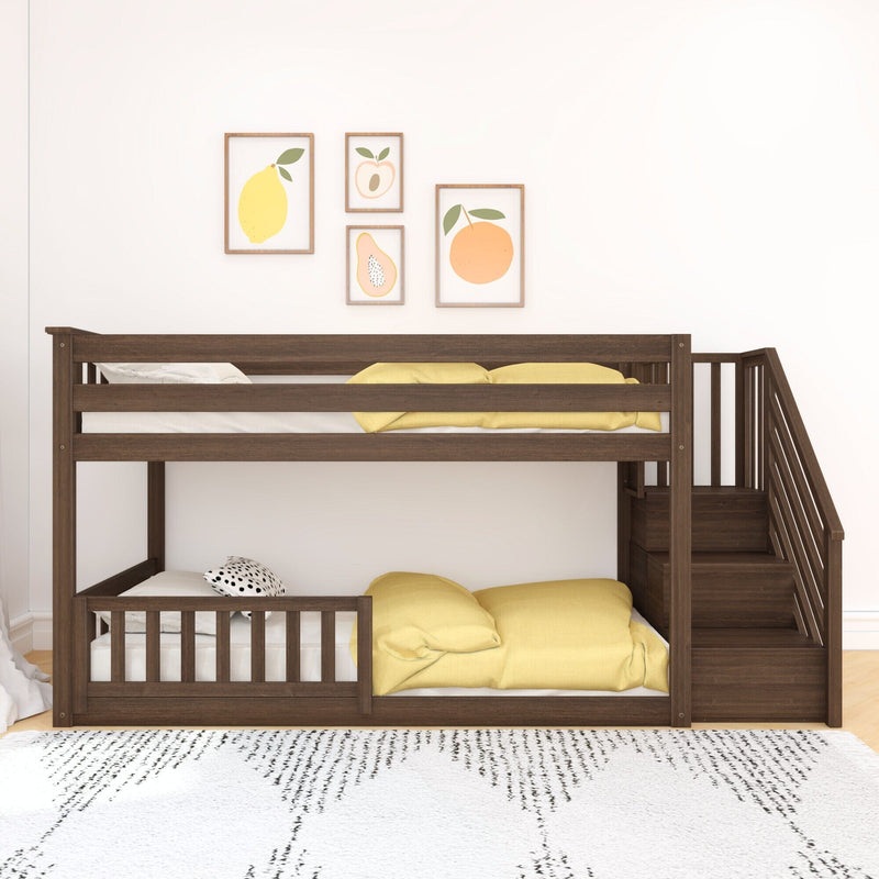 Wooden bunk bed with stairs and yellow bedding in a bright bedroom with fruit-themed wall art.