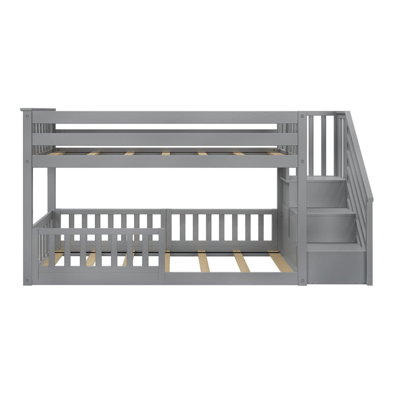Gray wooden bunk bed with storage stairs and safety rails.