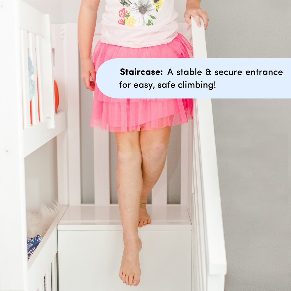 Child climbing white staircase safely with pink skirt.