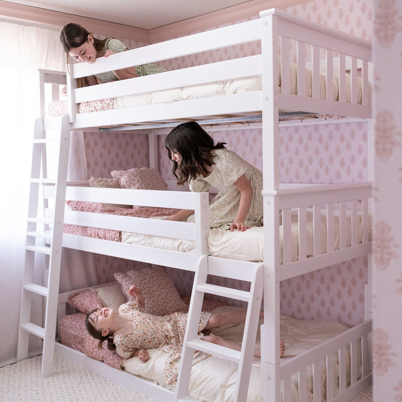 Triple bunk bed with children playing in a pink-themed bedroom.