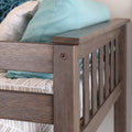Wooden baby crib side rail with aqua pillow and gray striped nursery bedding, modern nursery decor close-up