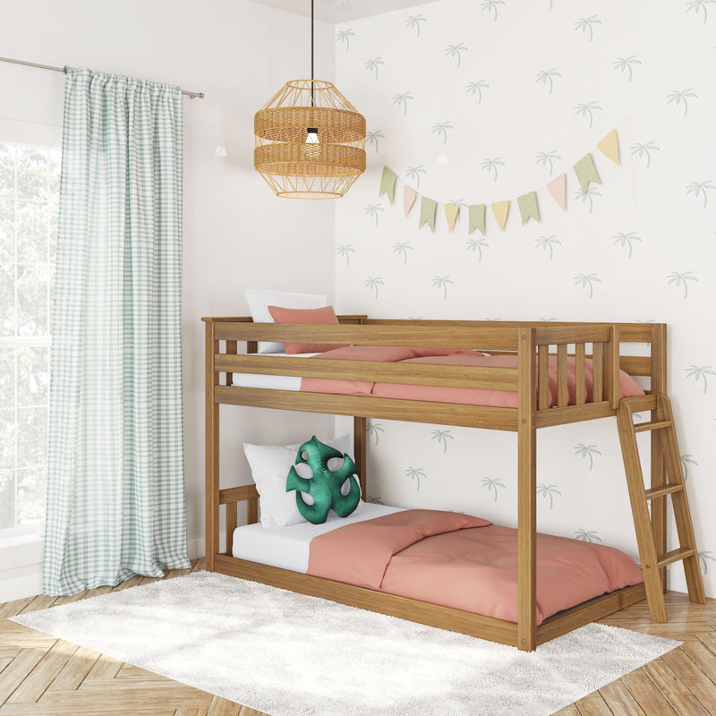 Wooden bunk bed in pastel kids' bedroom with coral bedding, gingham curtains, palm-print wallpaper, bunting and rattan pendant light