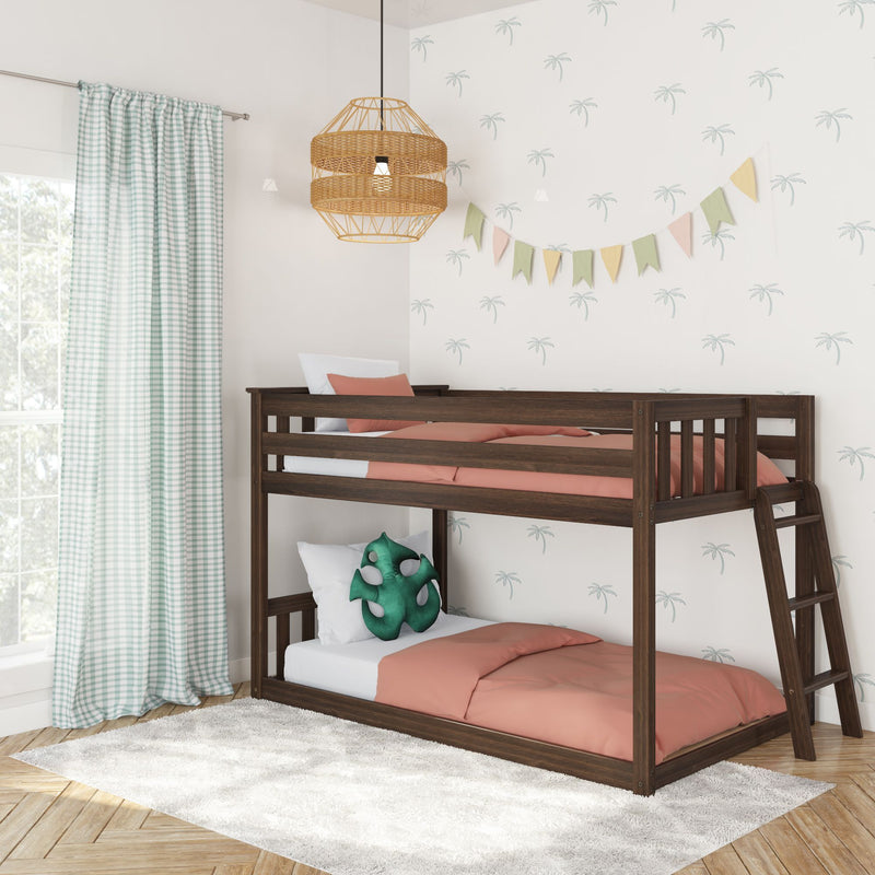 Children's bedroom with dark wood bunk bed, coral bedding, mint gingham curtains, rattan pendant light, palm-print wallpaper and pastel bunting