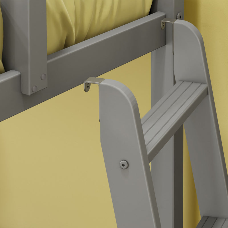 Close-up of gray folding step ladder mounted on yellow wall showing hinge, bolts and slatted step treads