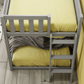 Top view of a modern gray bunk bed ladder with yellow bedding and a gray throw blanket on light wood plank flooring