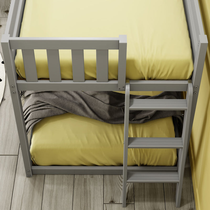 Top view of a modern gray bunk bed ladder with yellow bedding and a gray throw blanket on light wood plank flooring