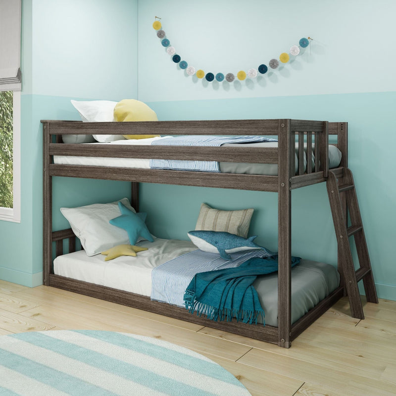 Gray wood twin-over-twin bunk bed with ladder in turquoise kids bedroom, space-saving design with nautical pillows, cozy bedding and decorative garland