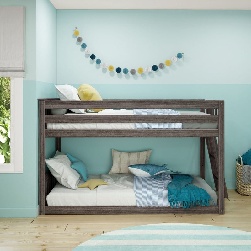 Gray wood twin bunk bed in a modern kids' bedroom with teal two-tone walls, striped bedding, whale plush toy, star pillow and pom-pom garland