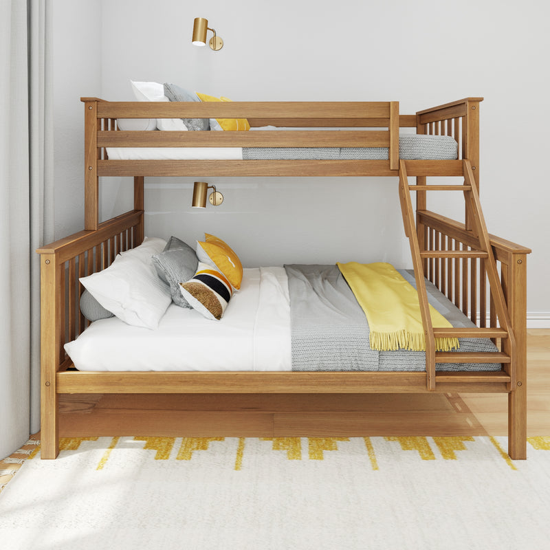 Modern wooden twin-over-full bunk bed with ladder, gray knit bedding and yellow accent pillows, brass wall sconces and neutral curtains in a bright kids' bedroom