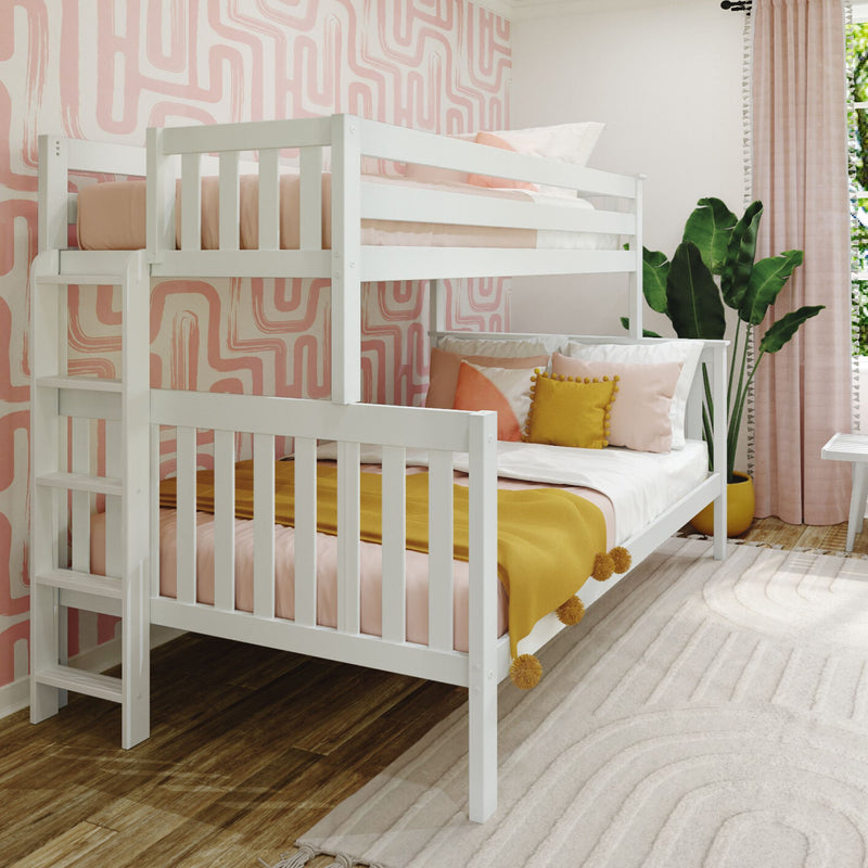 White wooden twin-over-full bunk bed in girls' bedroom with pink geometric wallpaper, mustard throw blanket, decorative pillows and indoor plant