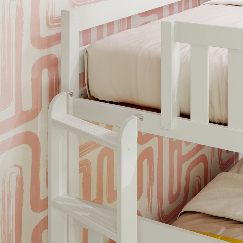 White wooden bunk bed with peach geometric wallpaper background, featuring a sturdy ladder and soft bedding.
