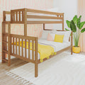 Two-level wooden bunk bed in bright kids' bedroom with yellow throw blanket and pillows, pink geometric wallpaper, white rug, and potted plant