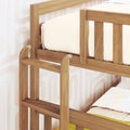 Wooden bunk bed ladder and safety guardrail in natural oak finish with neutral bedding and retro pastel wallpaper, space-saving kids bedroom furniture