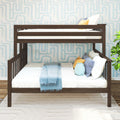 Dark wood bunk bed with white bedding and blue throw, colorful accent pillows and potted plant against light blue geometric wallpaper in a modern kids' bedroom