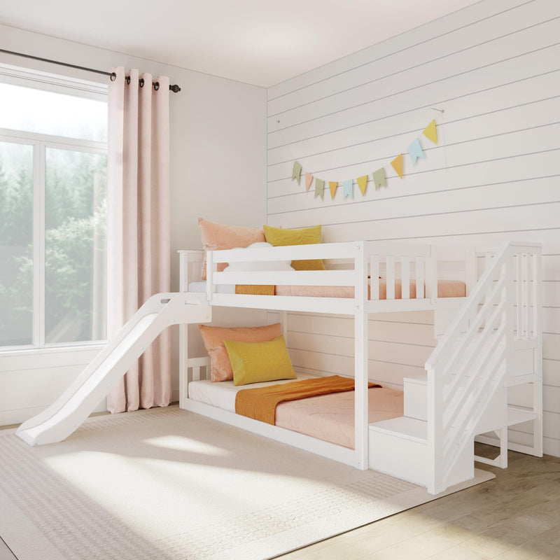 White kids bunk bed with slide and colorful bedding in bright, modern bedroom with natural light.